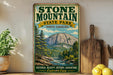 A vintage-style sign for Stone Mountain State Park in North Carolina, featuring a scenic mountain landscape with pine trees and a river.