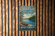 A vintage metal sign for Straight Lake State Park in Wisconsin, featuring a scenic image of a lake with a canoe and pine trees.