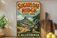 A vintage-style sign for Sugarloaf Ridge State Park in California, featuring a scenic mountain landscape.