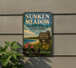A vintage-style sign for Sunken Meadow State Park in New York, featuring a scenic landscape with a beach, flowers, and a sign indicating the location.
