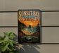 A vintage-style metal sign for Sunset Bay State Park in Oregon, featuring a scenic landscape with a sunset over the ocean and mountains.