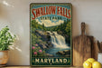 A vintage-style sign for Swallow Falls State Park in Maryland, featuring a scenic image of a waterfall surrounded by lush greenery.