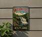 A vintage-style metal sign for Swallow Falls State Park in Maryland, featuring a waterfall and lush greenery.