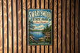 A vintage metal sign for Swartswood State Park in New Jersey, featuring a scenic landscape with a lake and pine trees.