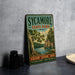 A vintage-style metal sign for Sycamore State Park, Ohio, featuring a scenic landscape with a lake and trees.
