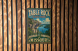 A vintage-style metal sign for Table Rock State Park in Missouri, featuring a scenic landscape with a cliff overlooking a lake.