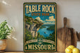 A vintage-style sign for Table Rock State Park in Missouri, featuring a scenic landscape with a lake and cliffs.
