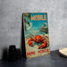 A vintage metal sign featuring a red crab and a boat, with the text "MOBILE" and "HOME MONITOR" displayed prominently.