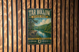 A vintage-style metal sign for Tar Hollow State Park in Ohio, featuring a scenic landscape with a river and forest.