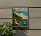 A vintage-style metal sign for Tettegouche State Park, featuring a scenic image of a waterfall and pine trees.