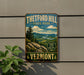 A vintage-style metal sign for Theftord Hill State Park in Vermont, featuring a scenic landscape with pine trees, mountains, and a winding river.