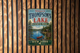 A vintage metal sign welcoming visitors to Thompson's Lake State Park in New York.