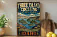 A vintage-style sign for Three Island Crossing State Park in Idaho, featuring a scenic illustration of the Snake River and the surrounding landscape.
