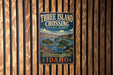 A vintage metal sign for Three Island Crossing State Park in Idaho, featuring a scenic illustration of the park's natural landscape.