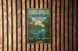 A vintage-style metal sign for Three Rivers State Park in Florida, featuring a tropical landscape with palm trees and a river.