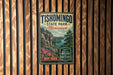 A vintage-style metal sign for Tishomingo State Park in Mississippi, featuring a scenic landscape with mountains, trees, and a river.