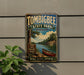 A vintage-style metal sign for Tombbee State Park in Mississippi, featuring a scenic image of a river, a canoe, and a forest.