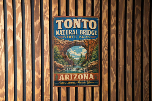 A vintage-style metal sign for Tonto Natural Bridge State Park in Arizona, featuring an illustration of the bridge and a waterfall.