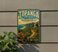 A vintage-style metal sign for Topanga State Park in California, featuring a scenic landscape with mountains, a beach, and a path leading through the vegetation.