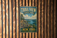 A vintage metal sign for Trail View State Park in New York, featuring a scenic landscape with a river and mountains.