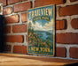 A vintage-style metal sign for Trail View State Park in New York, featuring a scenic landscape with a river and mountains.