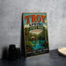 A vintage-style metal sign for Troy Spring State Park in Florida, featuring a scenic image of the park and its surroundings.