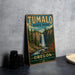 A vintage-style sign for Tumalo State Park, featuring a scenic image of a waterfall and forest, is displayed on a gray countertop.