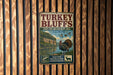 A vintage metal sign for the Turkey Bluffs State Fish and Wildlife Area in Illinois, featuring a turkey, ducks, and a scenic landscape.