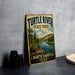 A vintage-style sign for Turtle River State Park in North Dakota, featuring a scenic illustration of a turtle in a river surrounded by pine trees and mountains.