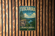 A vintage metal sign for Tuscarora State Park in Pennsylvania, featuring a scenic landscape with a river and mountains.