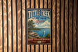 A vintage-style metal sign for Tuttle Creek State Park in Kansas, featuring a scenic landscape with a lake, trees, and a sailboat.