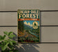 a vintage-style sign for the UKIAH-DALE FOREST, which is a scenic corridor in Oregon. The sign is mounted on a wall and depicts a winding road surrounded by lush greenery, including trees and mountains. The sign also includes the text "State Scenic Corridor" and "Oregon Scenic Byway", indicating that this is a designated scenic route in Oregon.