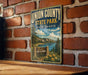 A vintage-style metal sign for Union County State Park in South Dakota, featuring a scenic landscape with mountains, trees, and a lake.
