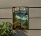 A metal sign for Union County State Park in South Dakota, featuring a scenic landscape with mountains, trees, and a lake.