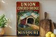 A vintage-style metal sign for the Union Covered Bridge in Missouri, featuring an illustration of the covered bridge and the state's name.