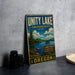 A vintage-style metal sign for the Unity Lake State Recreation Site in Oregon, featuring a scenic landscape with a lake, mountains, and pine trees.