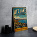 A vintage metal sign for Utah Lake State Park, featuring a scenic landscape with mountains, a lake, and a sailboat, along with the text "Adventure and Relaxation Start Here" and "New Mexico Land of Enchantment".