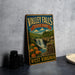 A vintage-style metal sign for Valley Falls State Park in West Virginia, featuring a waterfall and a scenic landscape.