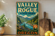 A vintage-style metal sign for "Valley of the Rogue State Park" in Southern Oregon, featuring a scenic mountain landscape with a river.