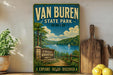 A vintage-style sign for Van Buren State Park in Ohio, featuring a scenic landscape with a lake, mountains, and a sailboat.