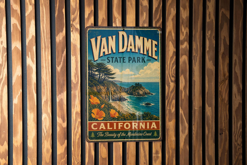 A vintage-style metal sign for Van Damme State Park in California, featuring a scenic coastal landscape with a beach, mountains, and a waterfall.