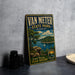 A vintage metal sign for Van Meter State Park in Missouri, featuring a scenic landscape with a lake, mountains, and a sailboat.