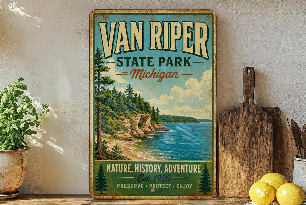 A vintage-style sign for Van Riper State Park in Michigan, featuring a scenic landscape with a lake and mountains.