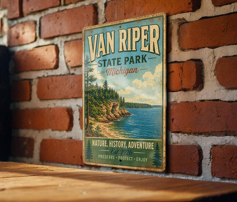 A vintage-style metal sign for Van Riper State Park in Michigan, featuring a scenic landscape with a lake and mountains.