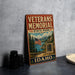 A vintage metal sign for the Veterans Memorial State Park in Idaho, featuring an American flag and a scenic landscape.