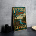 A vintage-style sign for Victoria, Georgia State Park, featuring a scenic landscape with a lake, pine trees, and mountains.
