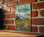 A vintage-style metal sign for Viento State Park in Oregon, featuring a scenic landscape with mountains, trees, and a path leading through the area.