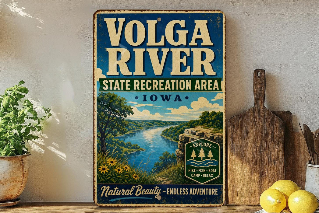 A vintage-style sign for the Volga River State Recreation Area in Iowa, featuring a scenic landscape with a river, trees, and mountains.