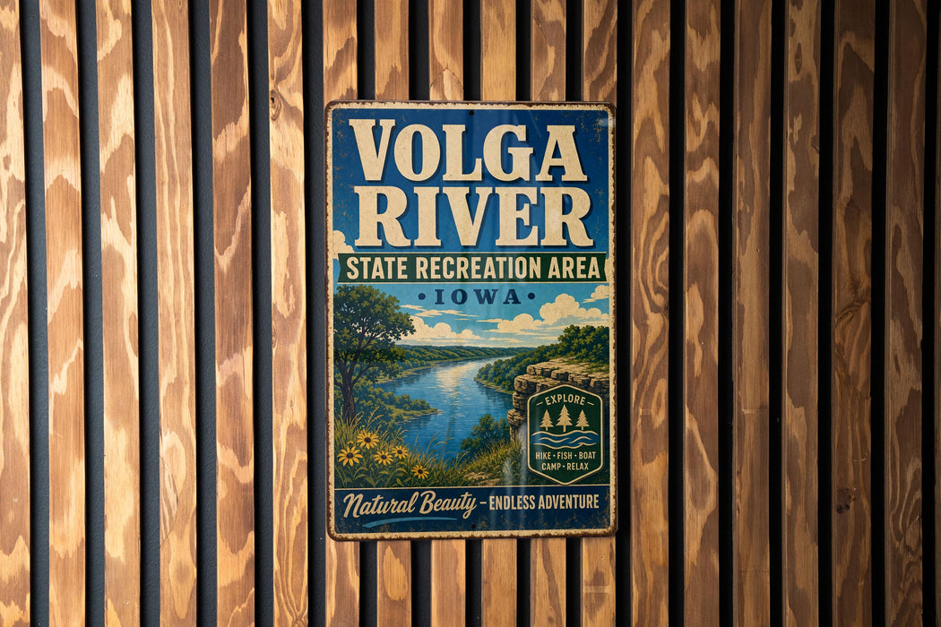 A vintage metal sign for the Volga River State Recreation Area in Iowa, featuring a scenic landscape with a river, trees, and a bridge.