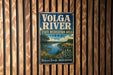A vintage metal sign for the Volga River State Recreation Area in Iowa, featuring a scenic landscape with a river, trees, and a bridge.